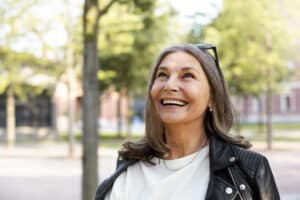 Cheerful,Overjoyed,Middle,Aged,Woman,Wearing,Sunglasses,On,Her,Head